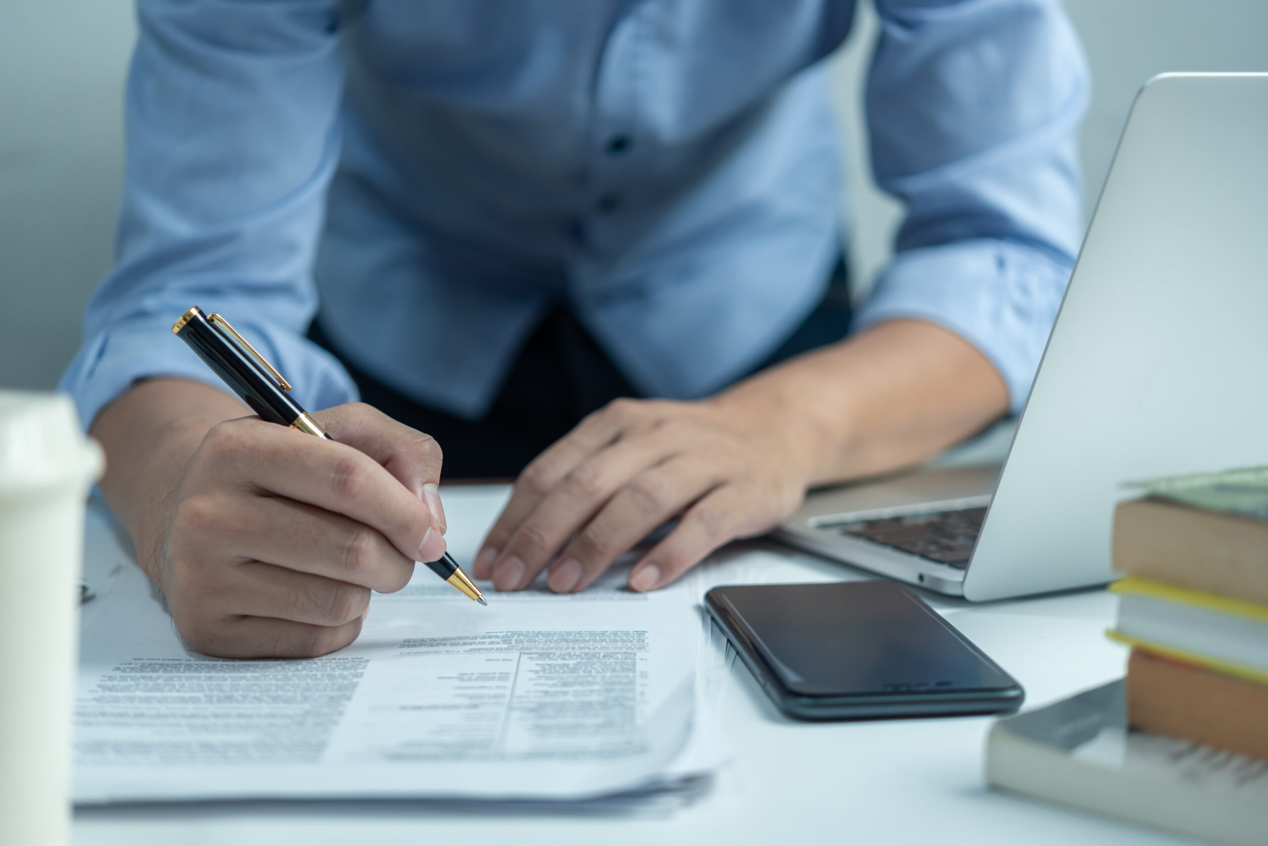 A male paralegal reviewing a print copy of a personal injury checklist.